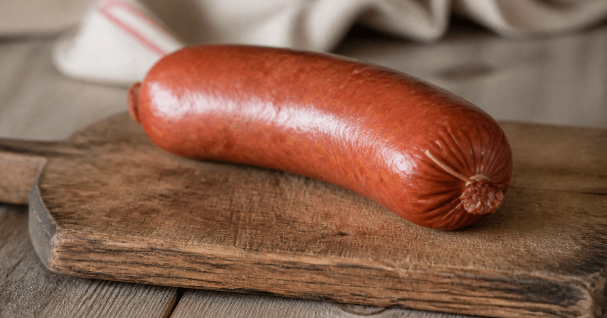 Saucisse de Morteau entiere posee sur planche bois rustique